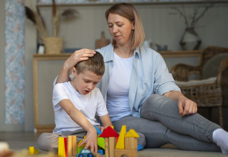 mother-playing-with-her-autistic-son-using-toys