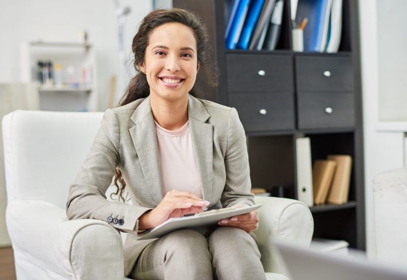 positive successful beautiful mixed race psychologist with clipboard sitting comfortable armchair looking camera personal office scaled r58j0ti92iw00so0mbtruk974k5wblzra0gkktdsak