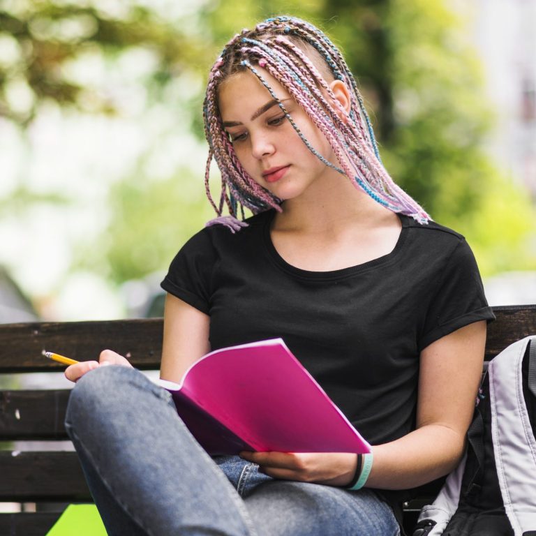 girl studying bench park scaled e1737656361943
